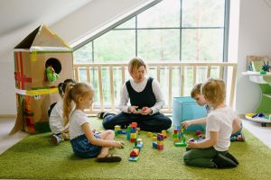 Early childhood educator working with children in an Alberta daycare classroom.