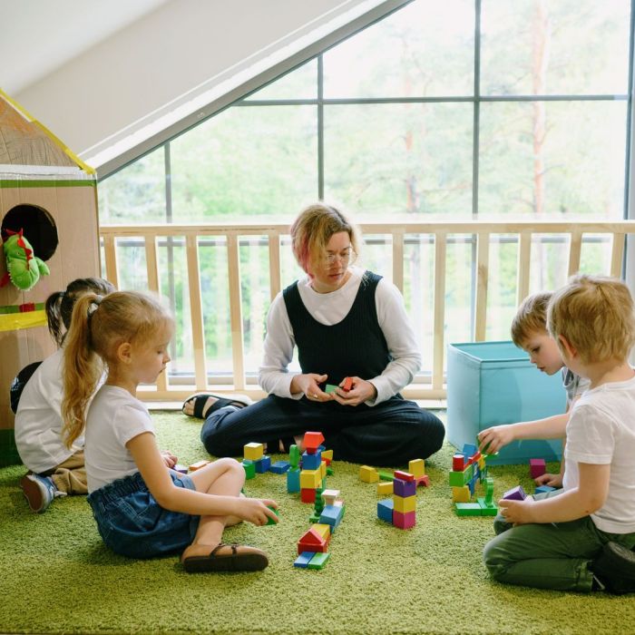Early childhood educator working with children in an Alberta daycare classroom.