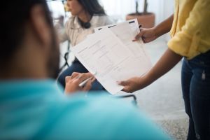 Business professionals analyzing reports during an office meeting.